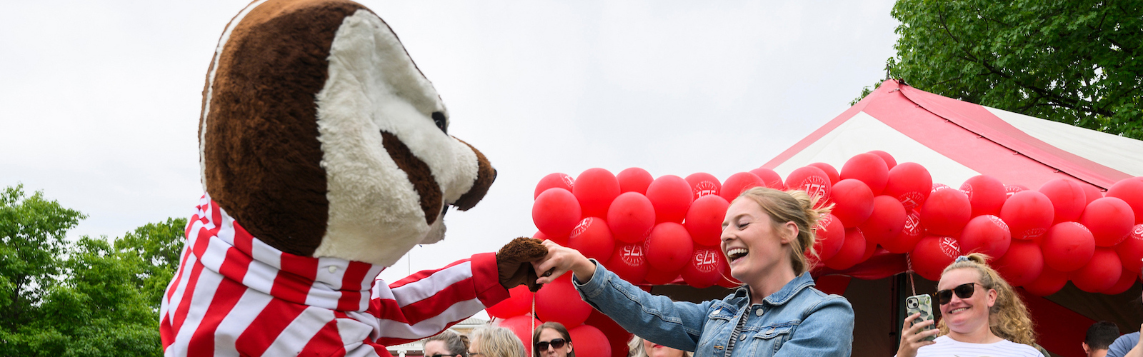 Bucky Badger dancing with woman outside
