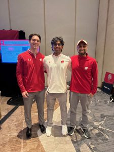Three men standing and smiling