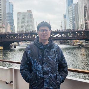 Man with city and river in background