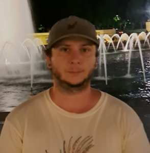 Man in hat by fountain